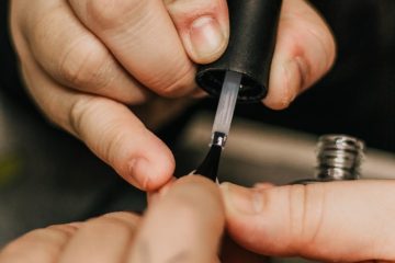person holding black and silver hand tool