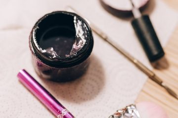 Close-up of nail salon tools and cosmetics on a table, for manicure and nail care.